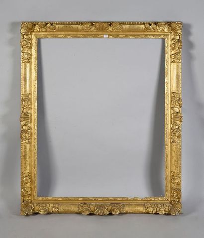 Carved and gilded oak frame with flower and...