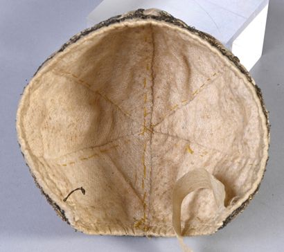 Embroidered bonnet of newborn, second third...