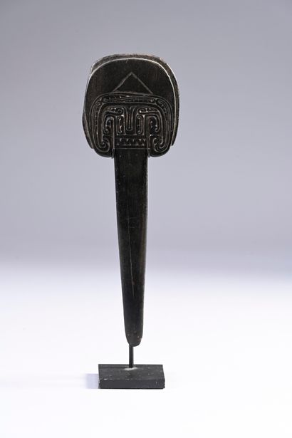 Crescent-shaped spatula with scroll decoration....