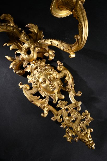 Pair of asymmetrical two-light sconces 
in...