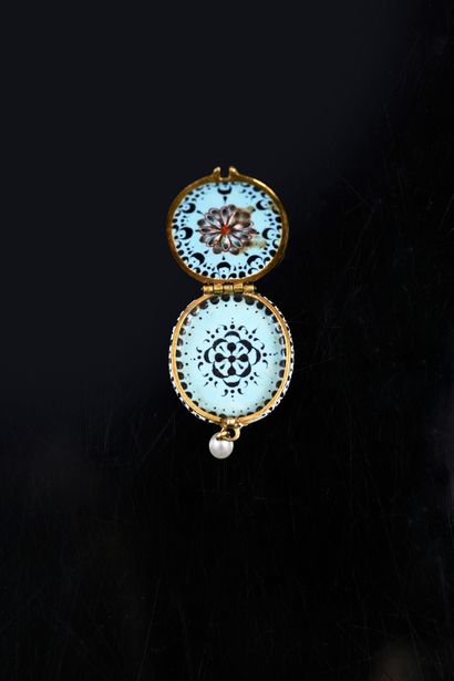 Oval-shaped medallion in enameled gold 
and...