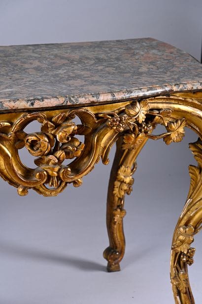 Carved, molded and gilded wood console 
and...