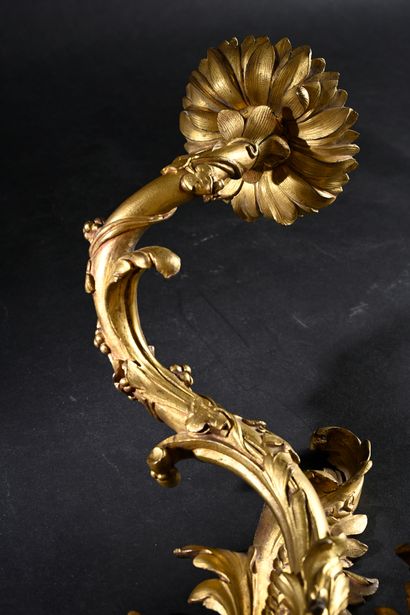 Pair of asymmetrical two-light sconces 
in...