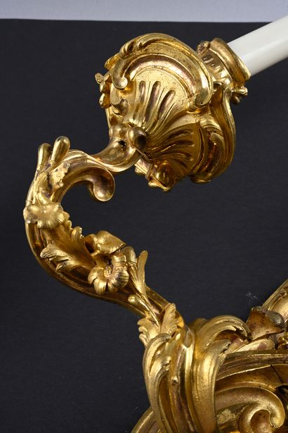 A pair of ormolu sconces with two asymmetrical...