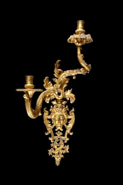 Pair of asymmetrical two-light sconces 
in...