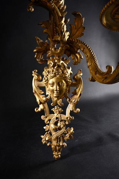 Pair of asymmetrical two-light sconces 
in...