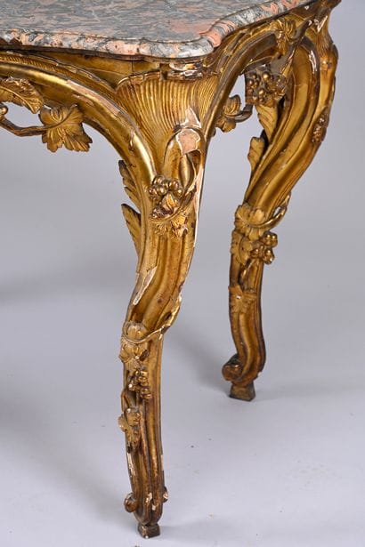 Carved, molded and gilded wood console 
and...