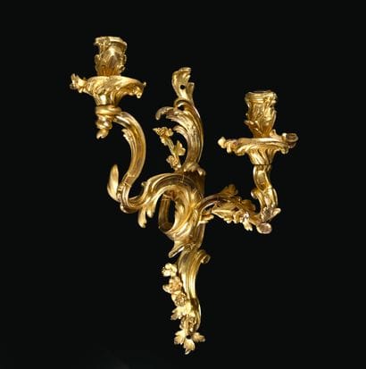 A pair of ormolu sconces with two asymmetrical...