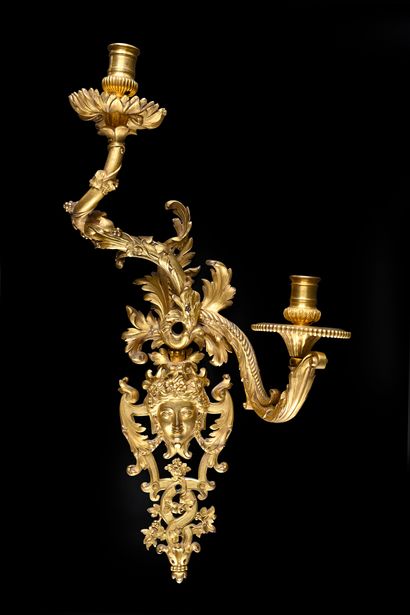Pair of asymmetrical two-light sconces 
in...