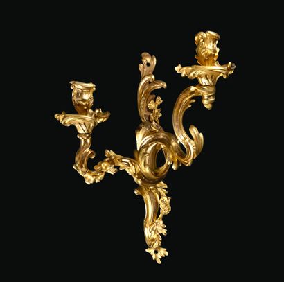 A pair of ormolu sconces with two asymmetrical...