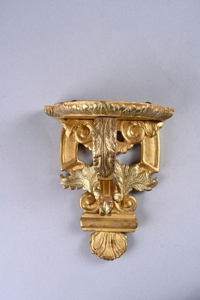 Pair of wall brackets in molded wood, 
carved...