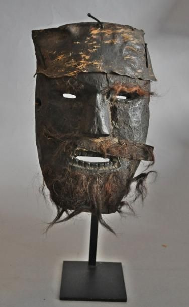 Masque chamanique, figurant une tête d'homme.En...