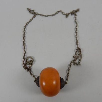 Collier orné d'une boule en ambre. Poids...