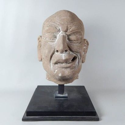 Tête de Lohan en grès. Le visage grimaçant....