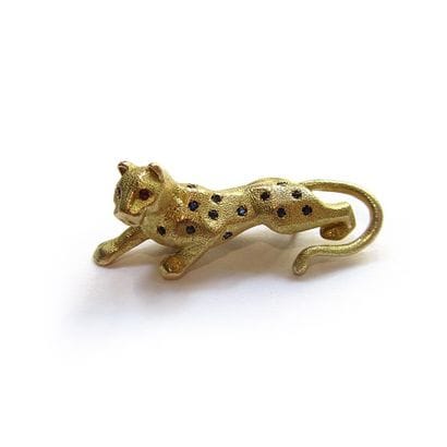 BROCHE en or jaune 18k (750/°°), stylisant...