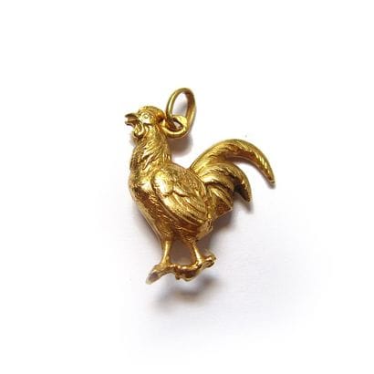 BRELOQUE en or jaune 18k (750/°°), stylisant...