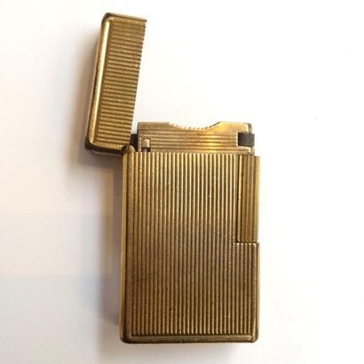 24 bis. DUPONT. Briquet en plaqué or, motif...
