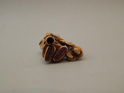 Netsuke en ivoire représentant un homme tenant...