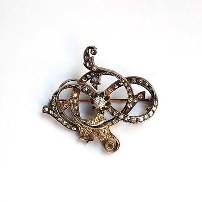 BROCHE en or 18k (750°/°°) et argent figurant...