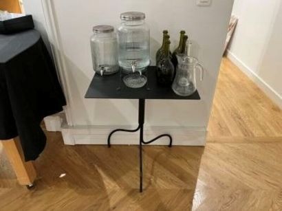 Pair of black lacquered metal pedestal tables...