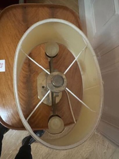 1 two-arm brass table lamp on oval base resting...