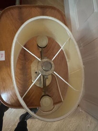 1 two-arm brass table lamp on oval base resting...
