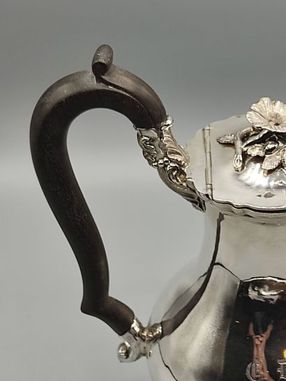 Silver coffee pot.

Rests on a base contours...