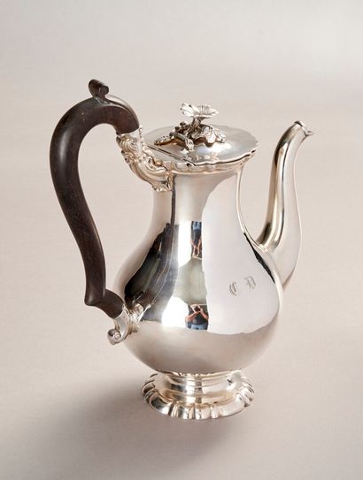 Silver coffee pot.

Rests on a base contours...
