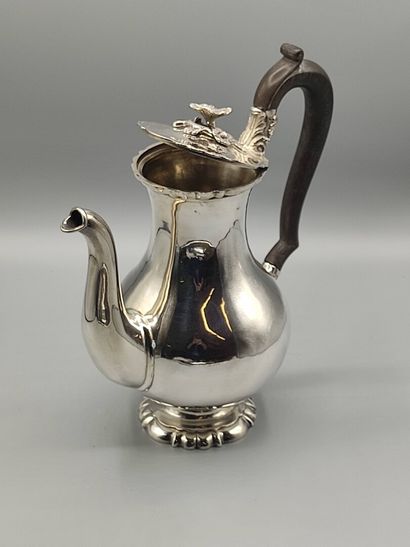 Silver coffee pot.

Rests on a base contours...