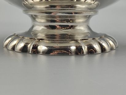 Silver coffee pot.

Rests on a base contours...