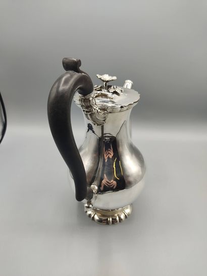 Silver coffee pot.

Rests on a base contours...