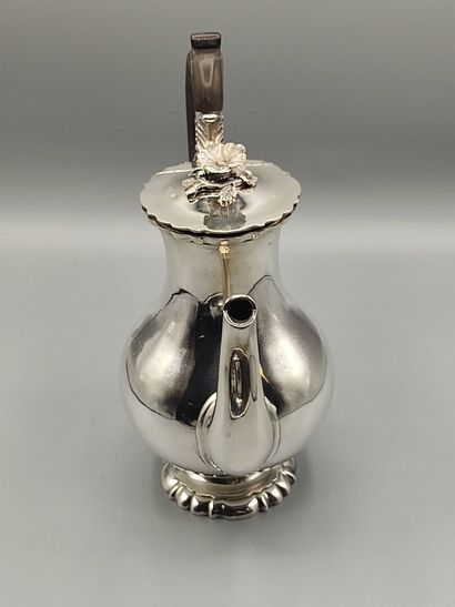 Silver coffee pot.

Rests on a base contours...