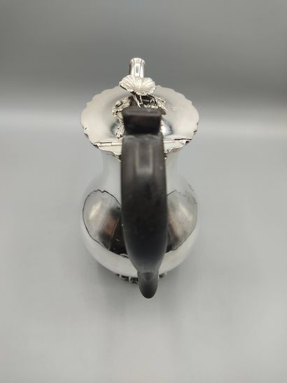 Silver coffee pot.

Rests on a base contours...