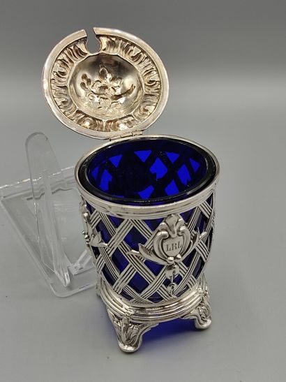 Silver mustard pot resting on four feet....