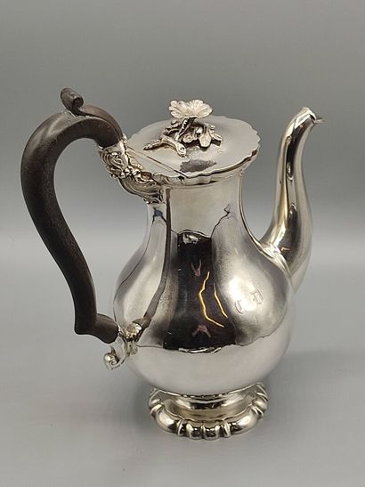 Silver coffee pot.

Rests on a base contours...