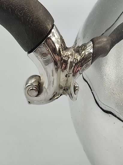 Silver coffee pot.

Rests on a base contours...