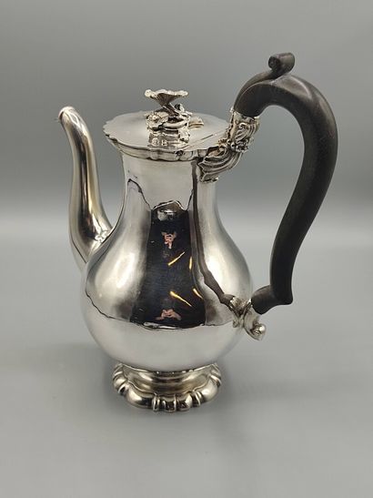 Silver coffee pot.

Rests on a base contours...