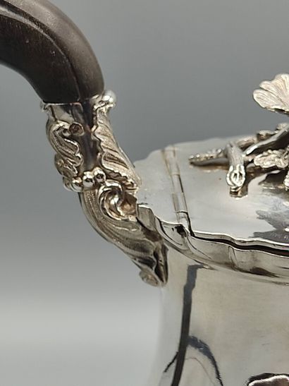 Silver coffee pot.

Rests on a base contours...