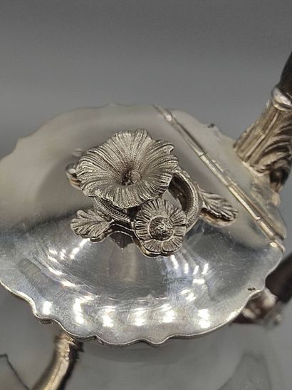 Silver coffee pot.

Rests on a base contours...
