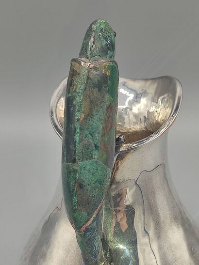 Hammered silver pitcher with a parrot shape...