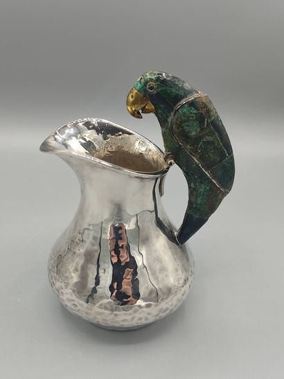 Hammered silver pitcher with a parrot shape...