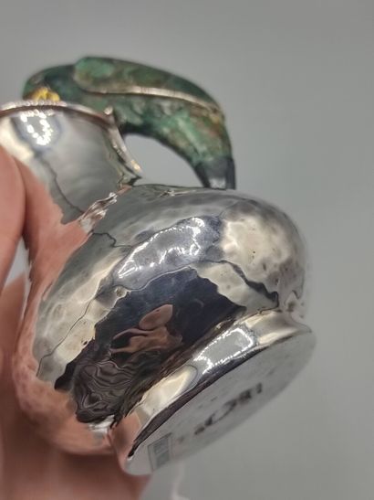 Hammered silver pitcher with a parrot shape...