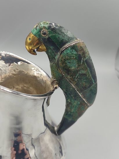 Hammered silver pitcher with a parrot shape...