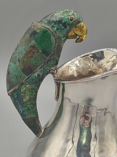 Hammered silver pitcher with a parrot shape...
