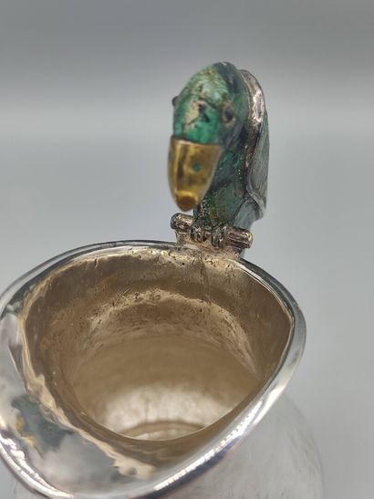Hammered silver pitcher with a parrot shape...