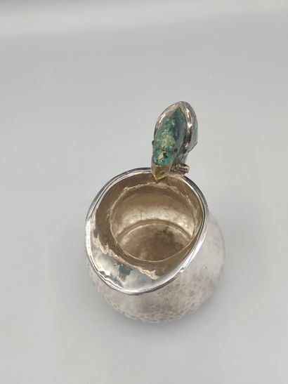Hammered silver pitcher with a parrot shape...