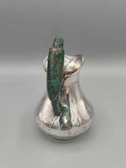 Hammered silver pitcher with a parrot shape...