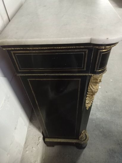 Meuble à hauteur d'appui en bois noirci.

Ouvre...