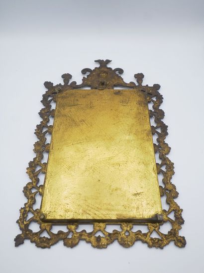 Miroir en bronze patiné.

Décor de tête feuillagée...