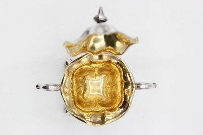 Mustard pot in silver resting on a quadripod...